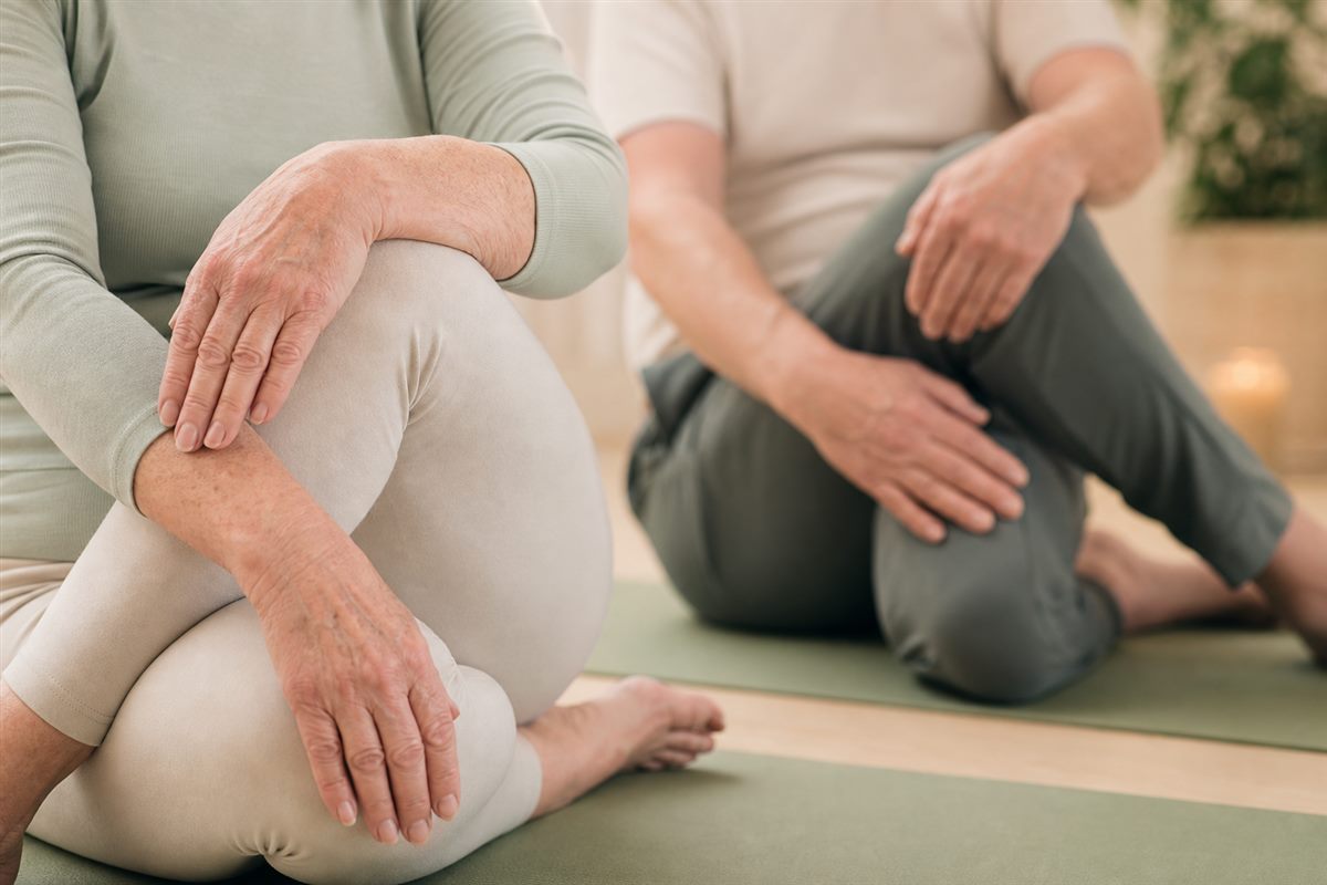 Hands resting calmly on knees during a seated breathing exercise